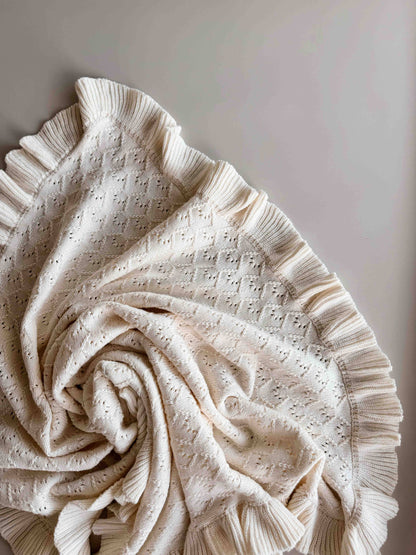 Beige textured blanket on a light beige background